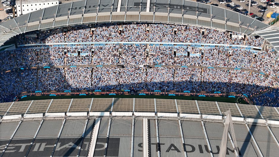 Aerial shot of Etihad Stadium filled with soccer fans in Manchester, UK.