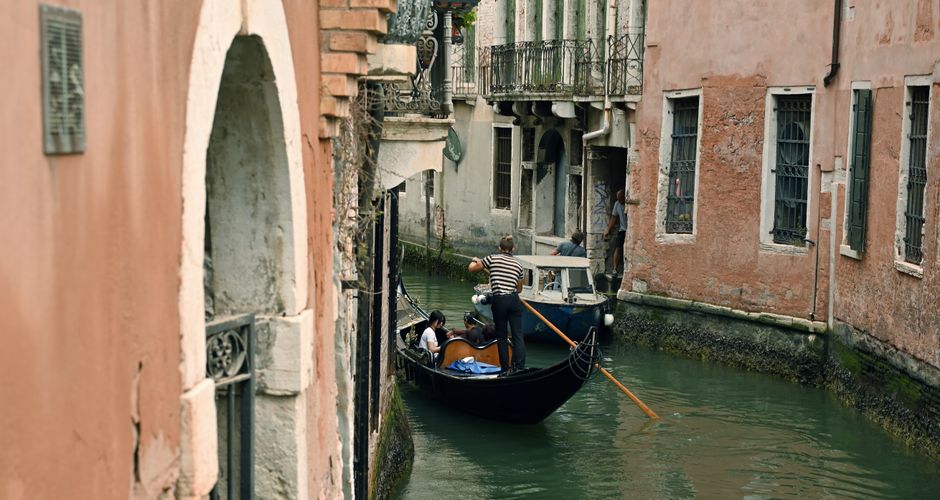 Serene gondola journey through the narrow canals of Venice, Italy.
